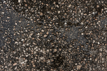 Wet concrete with water and small stones background texture