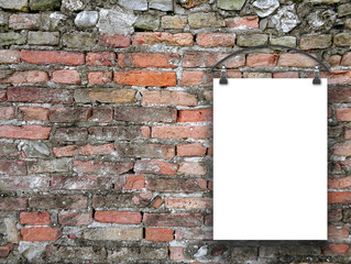 Close-up of one hanged paper sheet with clothes hanged on old weathered brick wall background