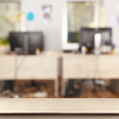 Empty wooden table and blurred office interior background