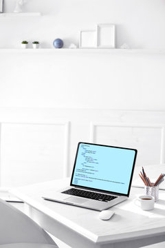 Programming code on laptop monitor