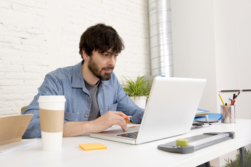 young hispanic hipster businessman working at computer home office