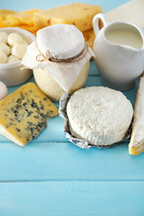Set of fresh dairy products on blue wooden table, close up