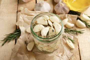 Garlic with spices on wooden table