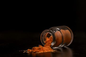 orange colorant powder in the jar - obrazy, fototapety, plakaty
