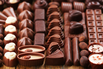 Assortment of delicious chocolate candies background, close up