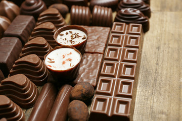 Delicious chocolate candies on wooden background