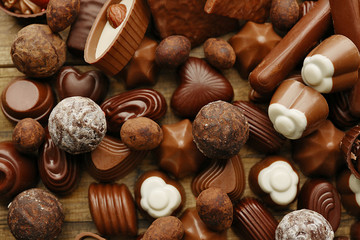 Assortment of delicious chocolate candies background, close up