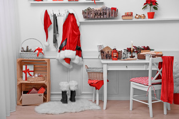 Santa costume hanging in white room