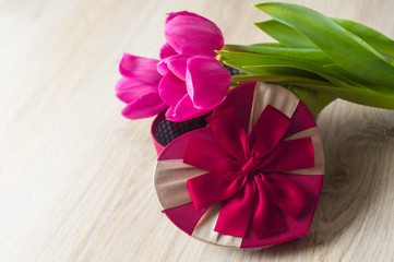three purple tulip and a box for gift