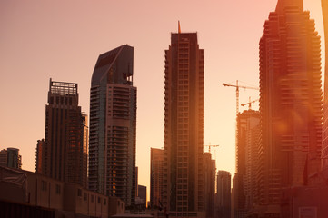 Fototapeta na wymiar construction of high-rise buildings on background sunrise
