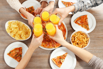 Friendly party with hot pizza and drinks, close up