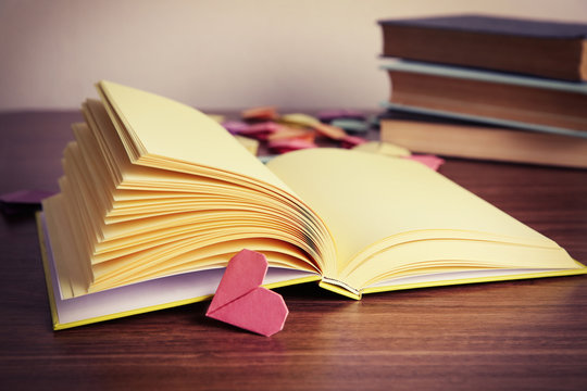 Heart bookmarks for books on wooden background