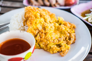 omelet served with steamed rice and chilli sauce on plate that i