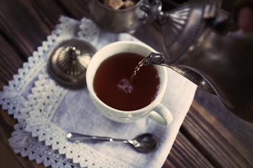 Tea pouring into the cup