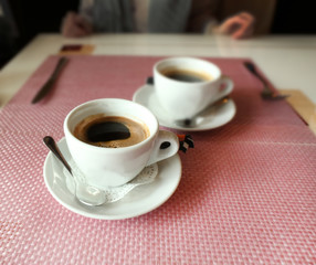 Cups of coffee on table in cafe, close up
