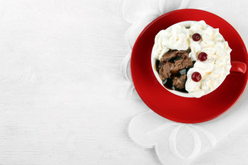 Chocolate mug cake with cream and cranberry on a white napkin