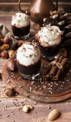hot chocolate in glass cups and cream with nuts