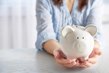 Woman holding piggy bank closeup