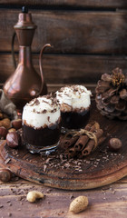 hot chocolate in glass cups and cream with nuts