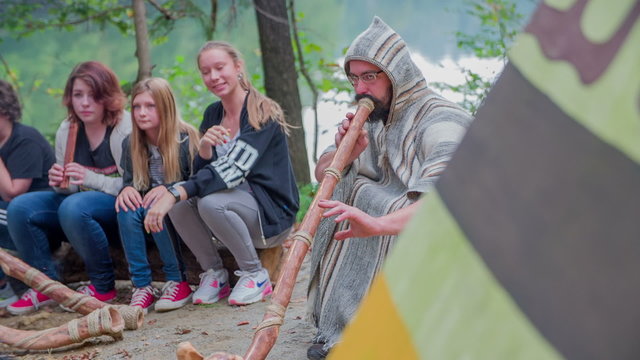 Mentor with children playing the didgeridoo