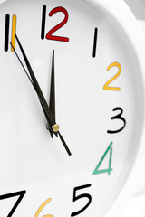 Round wall clock with colorful figures, close up
