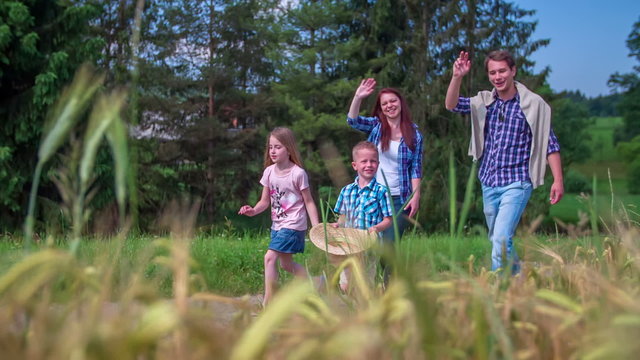 Family walking near wheat field  - Powered by Adobe
