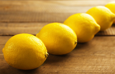 Fresh lemons on wooden background