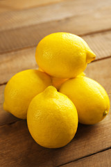 Fresh lemons on wooden background