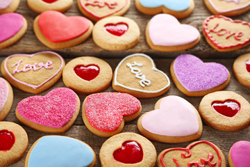 Assortment of love cookies on wooden background, closeup