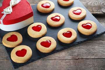 Assortment of love cookies with gift box on grey stand