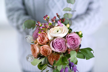 Woman holding a bouquet of roses, closeup