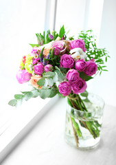 Glass jar of roses on a windowsill