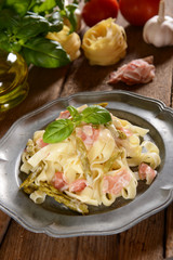 Tagiatelle pasta with asparagus and prosciutto ham
