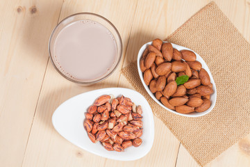 tiger peanut and almonds in bowl on wood