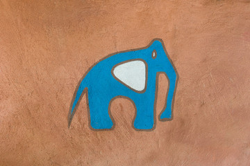 Cartoon elephant painted on the cement wall.