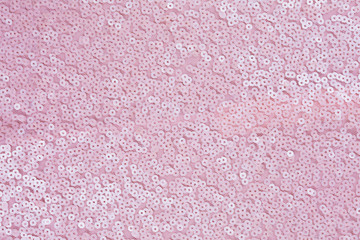 pink circular glitter on fabric background