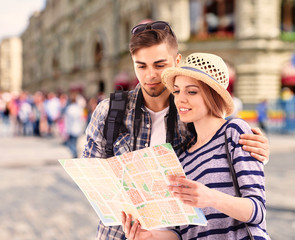 Young couple of travelers on the city background