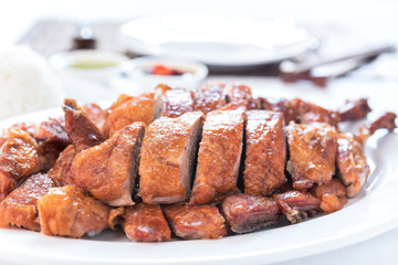 Roast duck, Chinese style on the white dish and white tablecloth