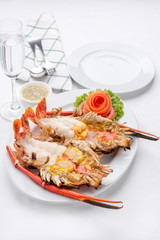 Roasted big river shrimp with spicy and sour sauce on the white tablecloth