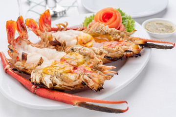 Roasted big river shrimp with spicy and sour sauce on the white tablecloth