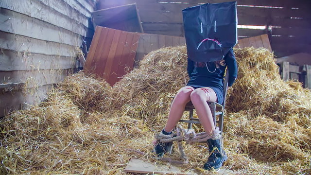 Sad victim in a barn