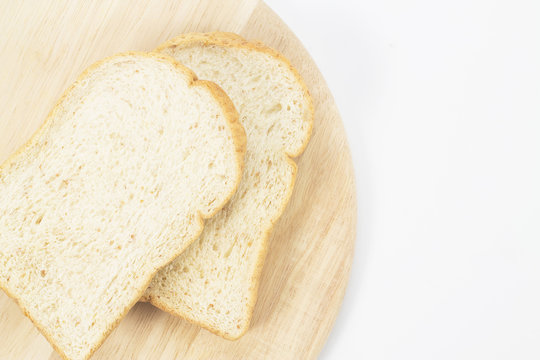 Place the bread on wood isolated white backdrop.