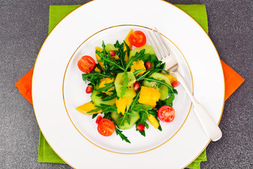 Fresh mango, arugula, kiwi, orange and pomegranate.