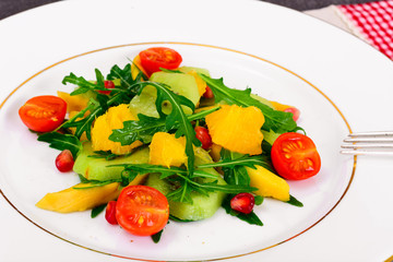 Fresh mango, arugula, kiwi, orange and pomegranate.