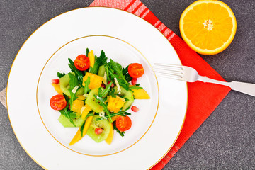 Fresh mango, arugula, kiwi, orange and pomegranate.