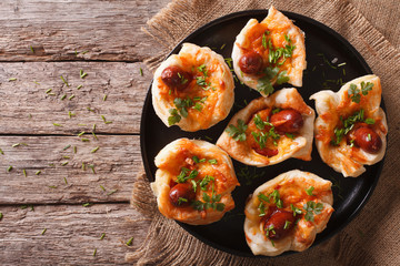muffins stuffed with sausage and cheese on a plate. horizontal top view 
