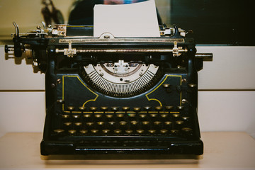 Antique vintage typewriter on the desk, old and rusty