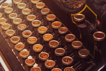 Antique vintage typewriter on the desk, old and rusty, keys close up, selective focus, retro filter