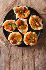 muffins stuffed with sausage and cheese on a plate. vertical top view 
