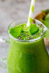 Spinach smoothie, on the grey  background.